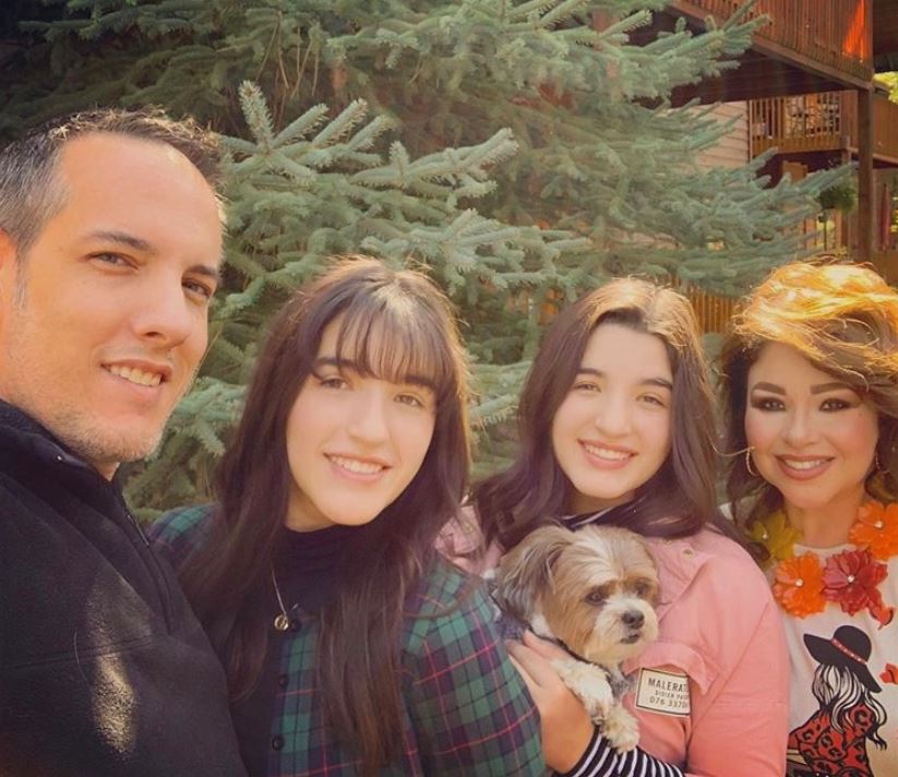 selfie of my dad, sister, mom, dog, and me standing in front of a tree